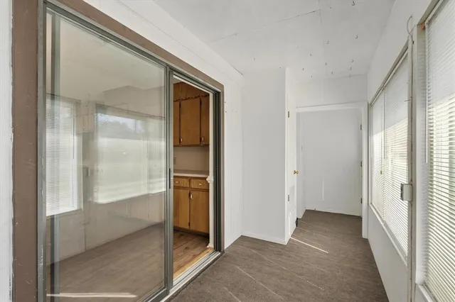 a large kitchen with stainless steel appliances granite countertop a stove top oven a sink dishwasher and white cabinets with wooden floor