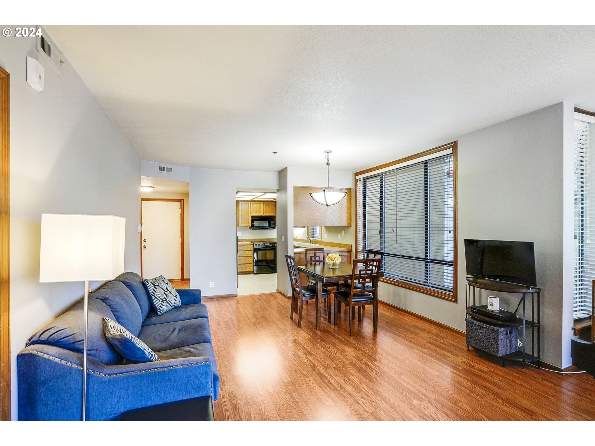 652 Wimbledon Court Eugene, OR 97401 - Photo 8 of 35 a living room with furniture and a flat screen tv with kitchen view