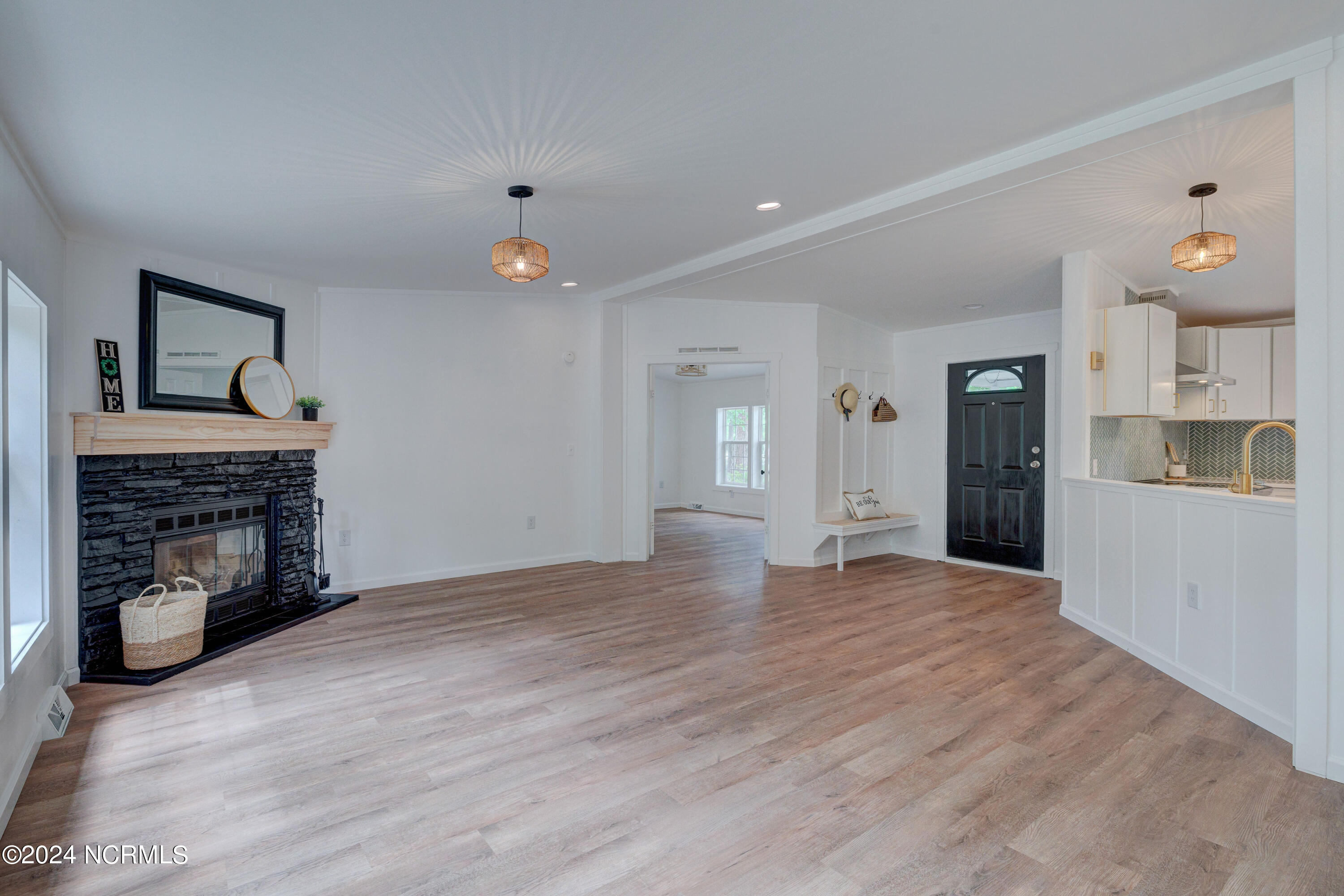 328 Groves Point Circle Hampstead, NC 28443 - Photo 12 of 39 Hall Tree and Fireplace Kitchen View