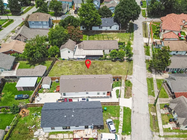 an aerial view of residential houses with outdoor space and street view