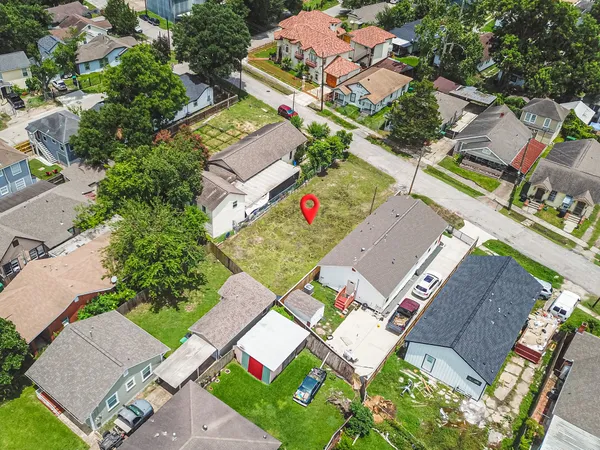 an aerial view of a house with a yard