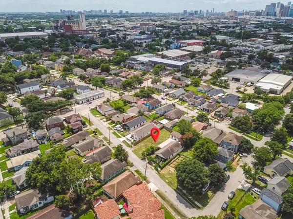 an aerial view of residential houses with city view