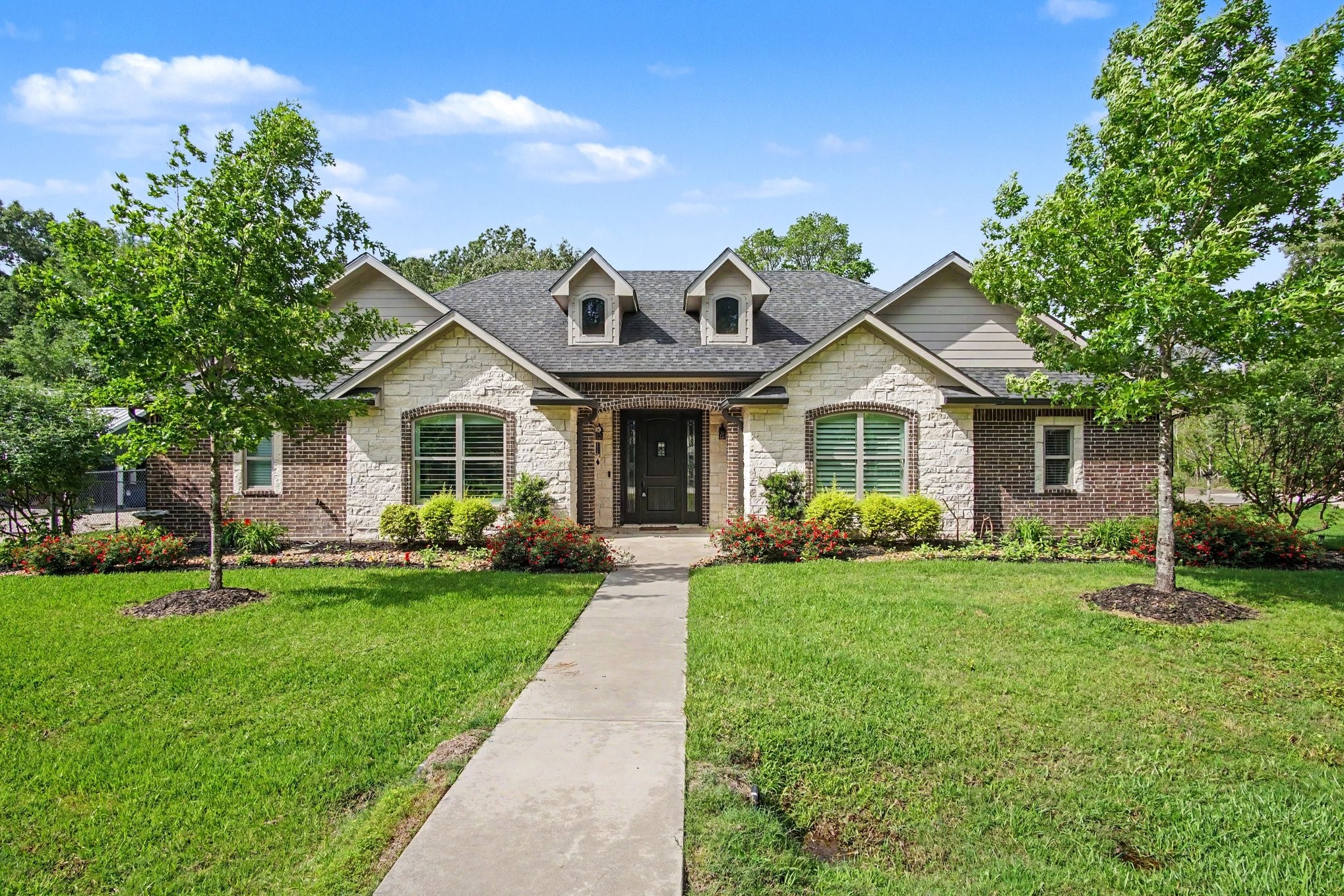 184 Bridgepoint Onalaska, TX 77360 - Photo 2 of 41 a front view of a house with a garden and porch