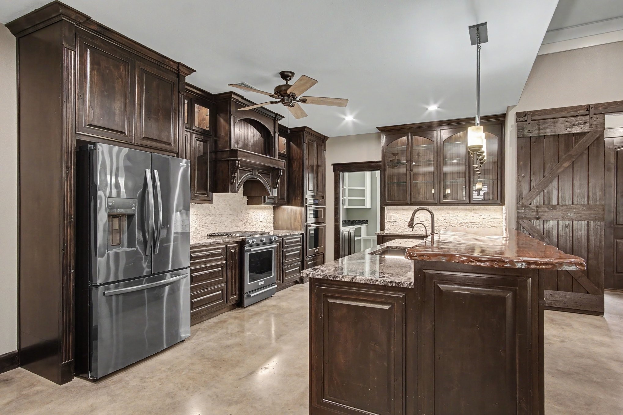 184 Bridgepoint Onalaska, TX 77360 - Photo 8 of 41 a kitchen with stainless steel appliances granite countertop a sink a stove and a refrigerator