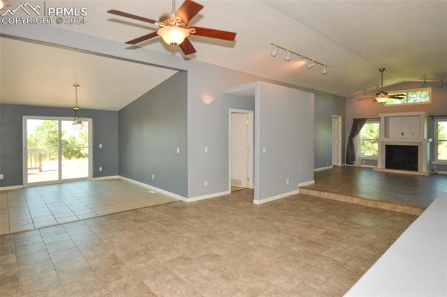 34115 Big Springs Road Yoder, CO 80864 - Photo 13 of 35 Unfurnished living room with light tile floors, plenty of natural light, rail lighting, and ceiling fan