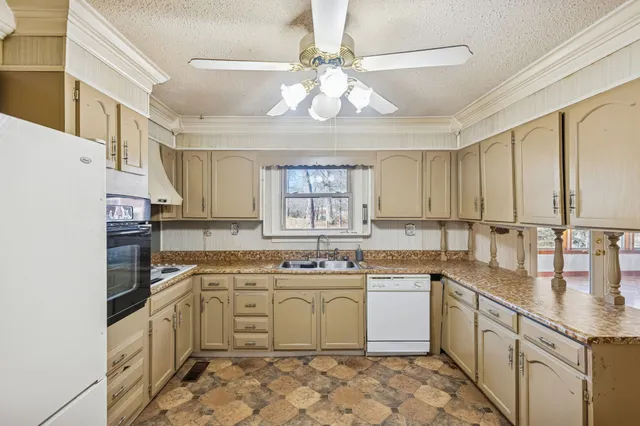 a kitchen with a sink stove and cabinets