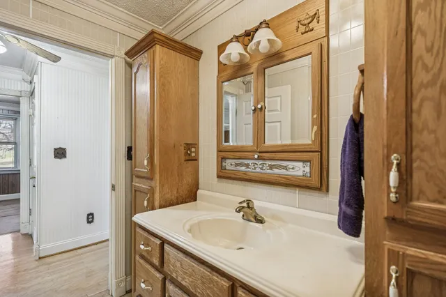 a bathroom with a sink a mirror and a shower