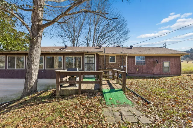 a view of a house with a yard covered in snow