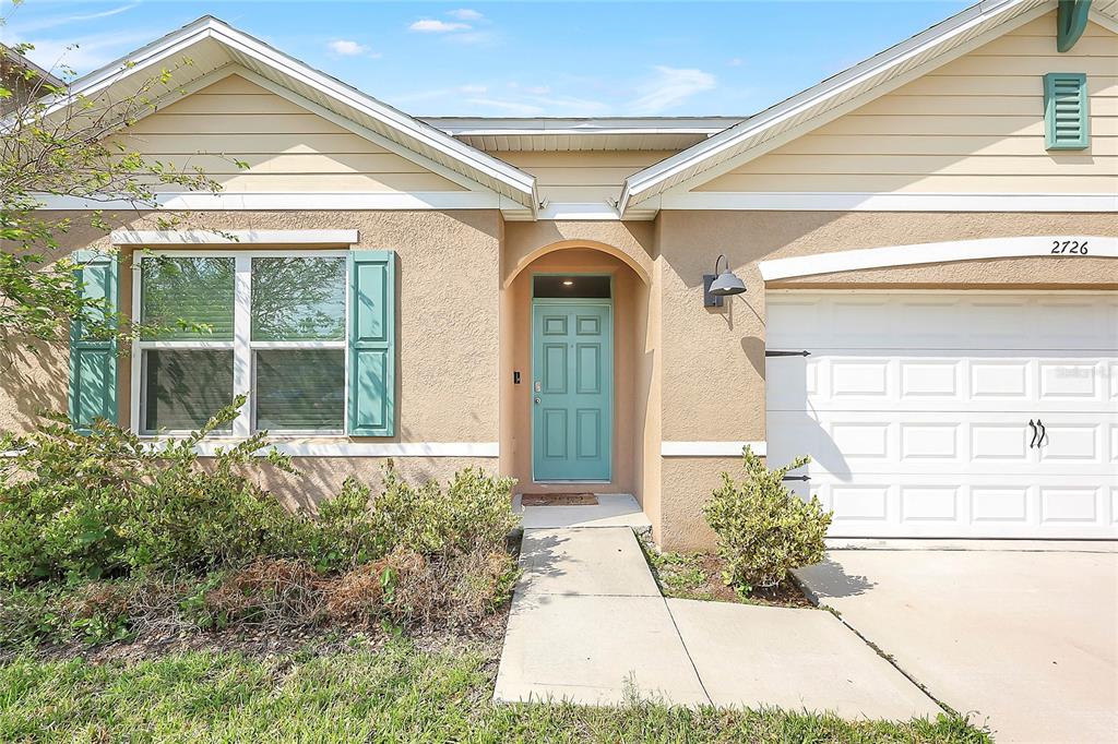 2726 Harmonia Hammock Road Harmony, FL 34773 - Photo 2 of 18 a front view of a house with garden