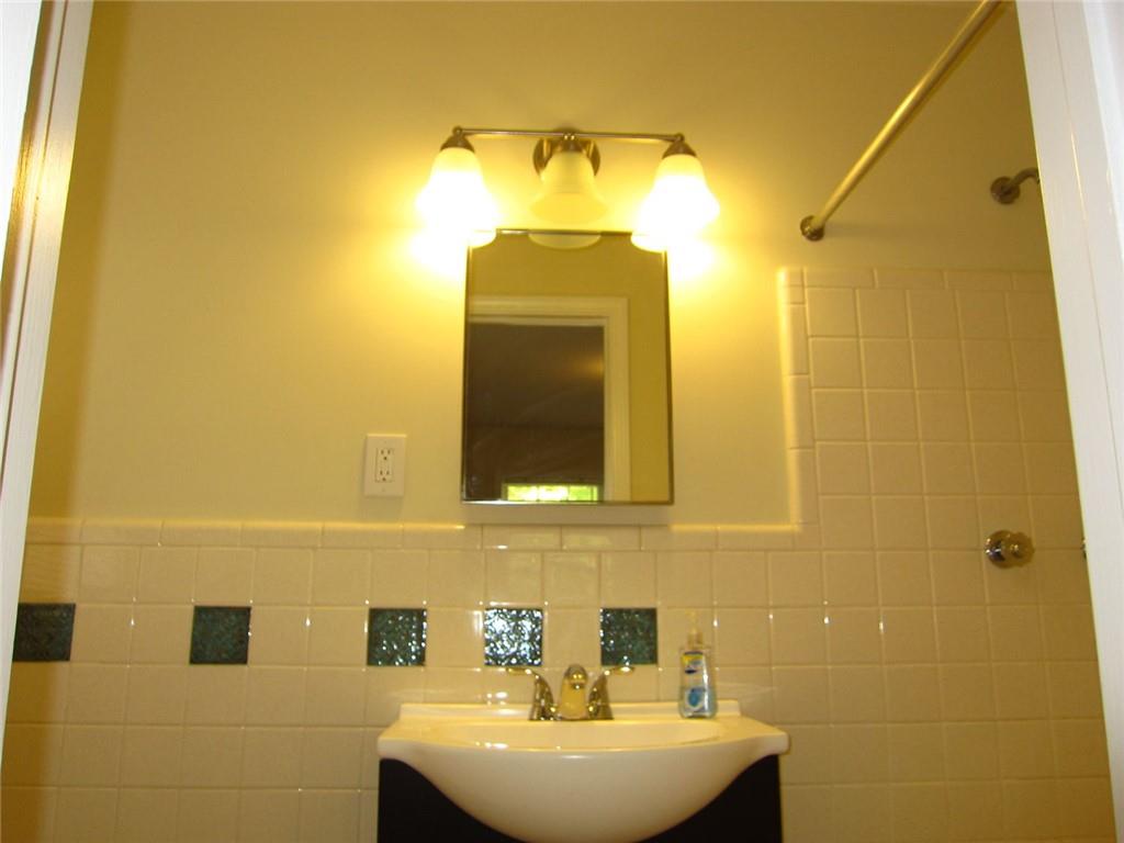 1740 Samaria Trail Tucker, GA 30084 - Photo 23 of 31 a bathroom with a sink a mirror and a shower