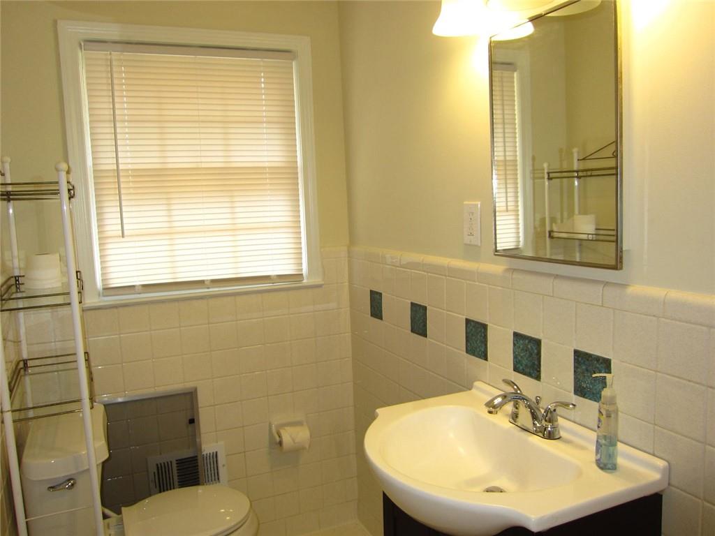 1740 Samaria Trail Tucker, GA 30084 - Photo 25 of 31 a bathroom with a sink a toilet and a mirror