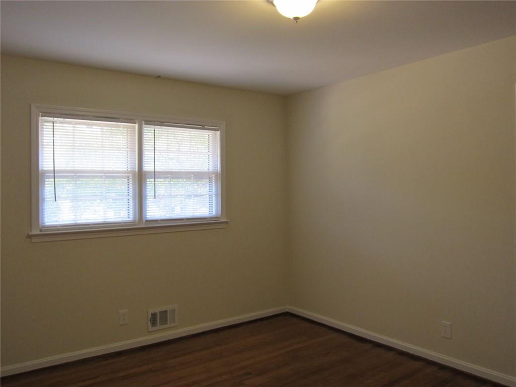 1740 Samaria Trail Tucker, GA 30084 - Photo 26 of 31 an empty room with wooden floor and windows