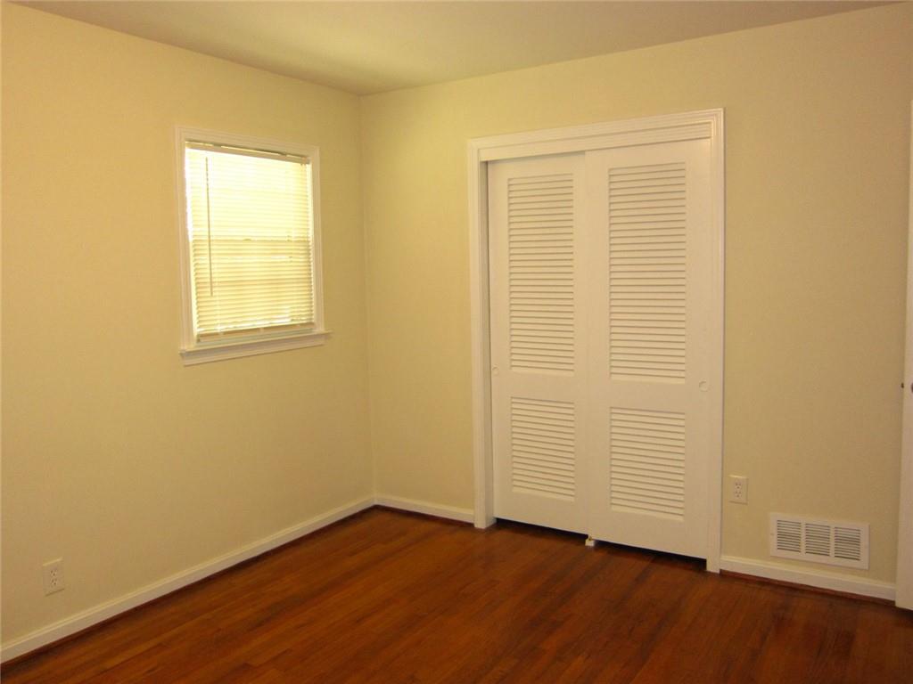 1740 Samaria Trail Tucker, GA 30084 - Photo 28 of 31 an empty room with wooden floor and a window