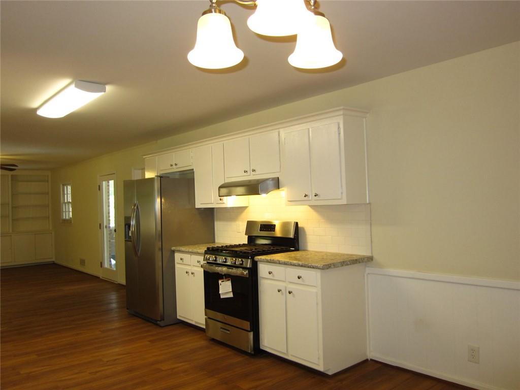 1740 Samaria Trail Tucker, GA 30084 - Photo 7 of 31 a kitchen with stainless steel appliances a sink a stove a refrigerator and cabinets