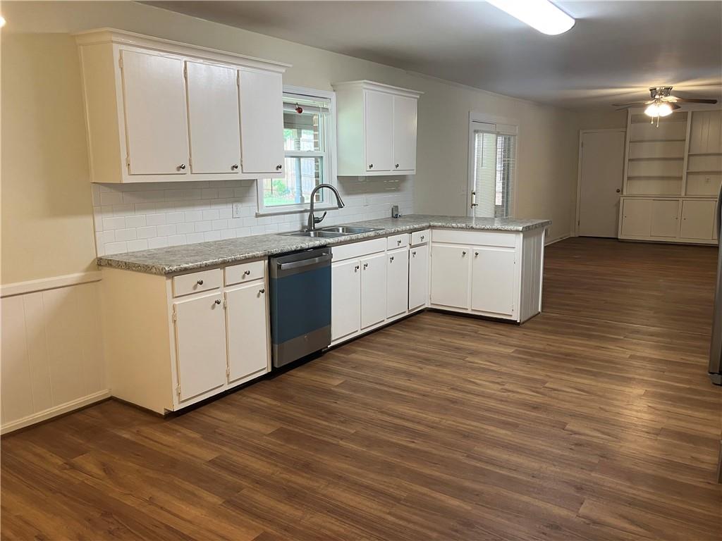 1740 Samaria Trail Tucker, GA 30084 - Photo 8 of 31 a kitchen with wooden floors and white cabinets