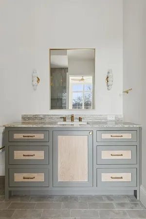 a bathroom with a sink vanity and mirror