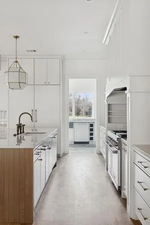 a kitchen with stainless steel appliances a sink and a large window