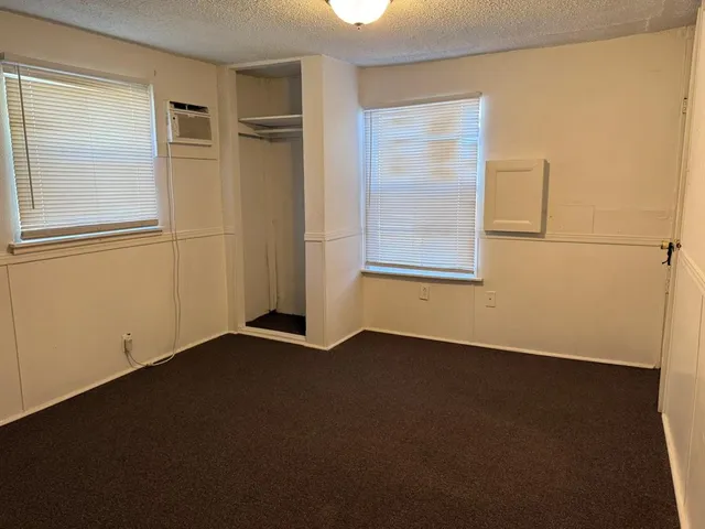 an empty room with a empty space and windows