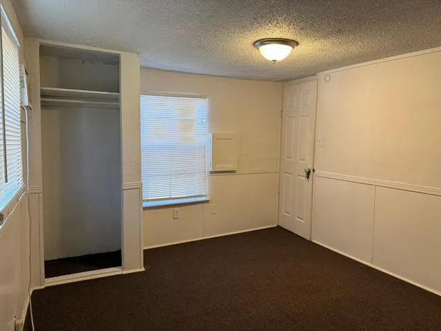 an empty room with a empty space and windows