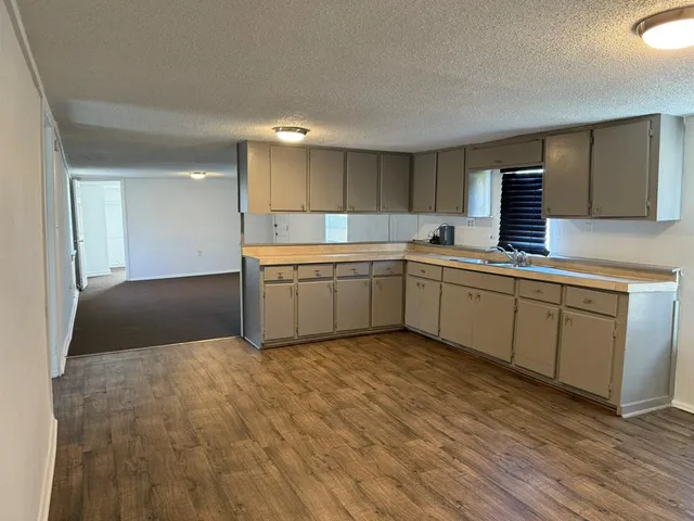a kitchen with a sink cabinets and stainless steel appliances