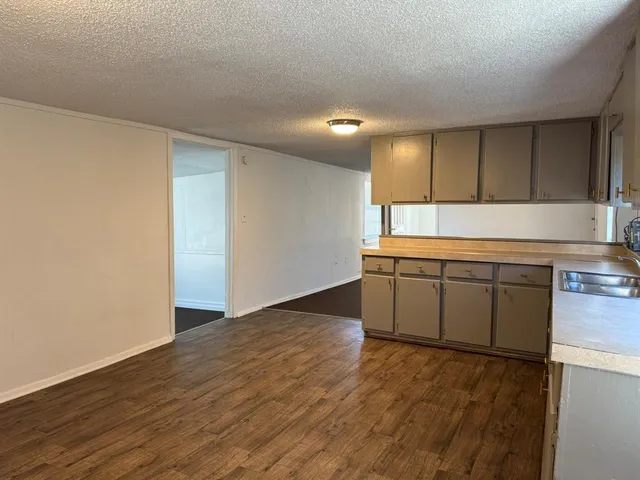 a view of a kitchen with a sink and a stove top oven