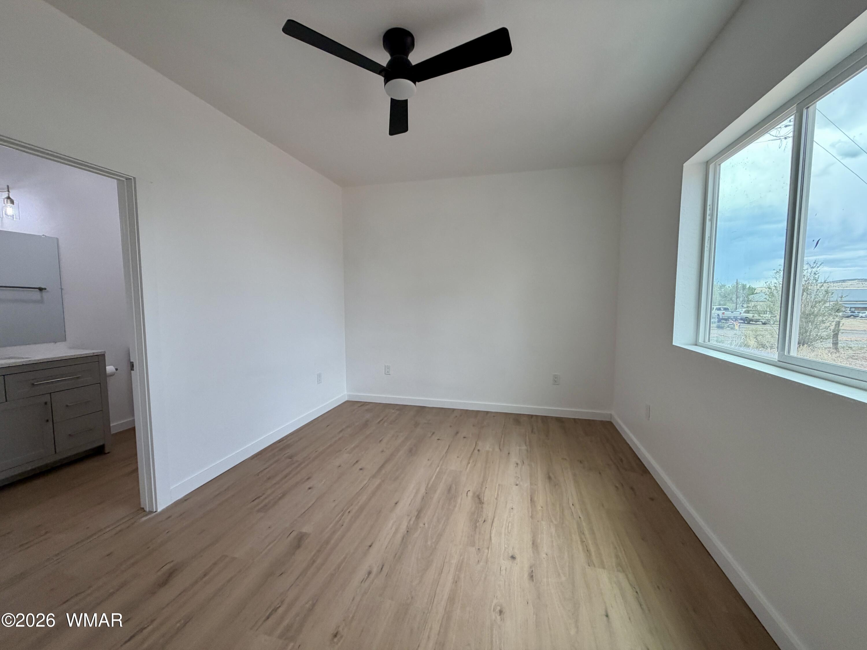 731 Tori Circle Springerville, AZ 85938 - Photo 10 of 19 an empty room with wooden floor and windows