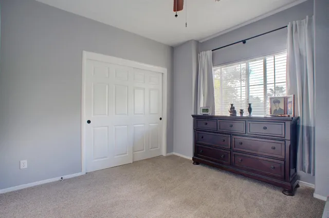 a room with a dresser and a window