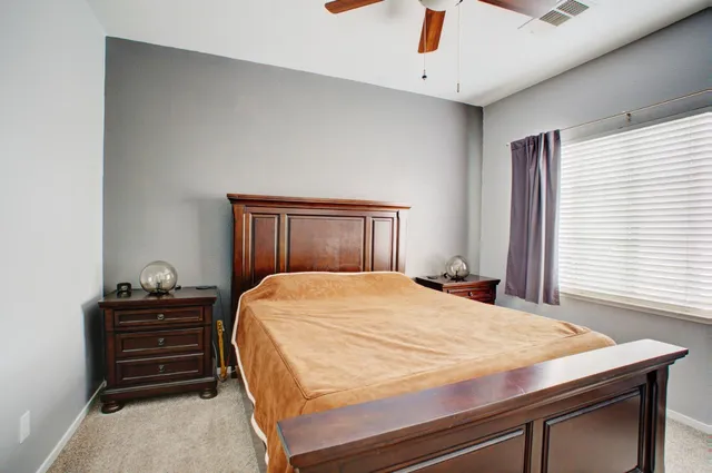 a bedroom with a bed and a dresser