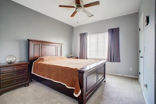 a bed sitting in a bedroom next to a window