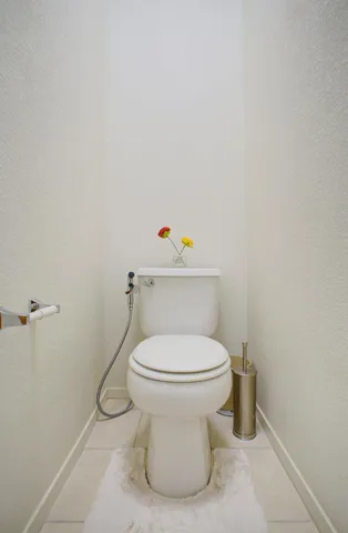 a white toilet sitting next to a white sink