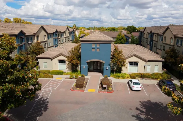 an aerial view of a house with swimming pool and furniture