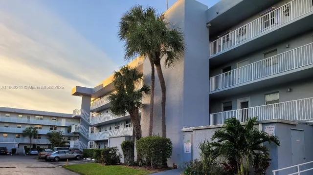 a front view of a building with a yard