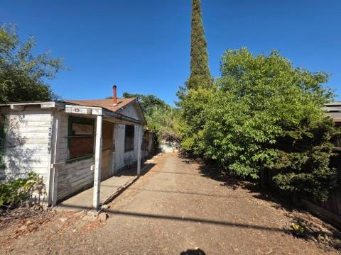 7076 Center Street Winton, CA 95388 - Photo 1 of 1 a view of a house with a yard and potted plants