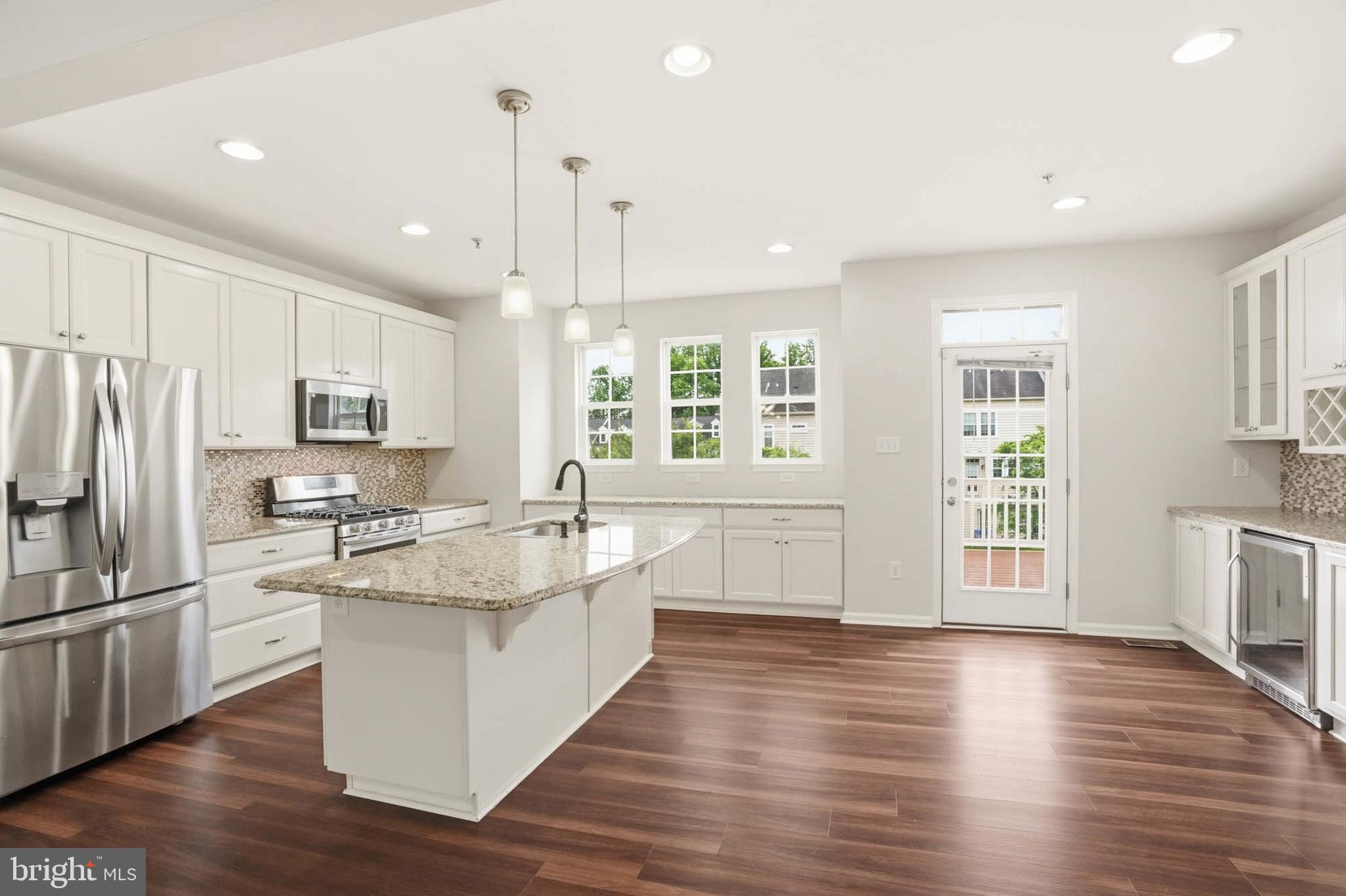 9817 Solar Course Laurel, MD 20723 - Photo 2 of 59 a kitchen with stainless steel appliances granite countertop a sink a stove and refrigerator