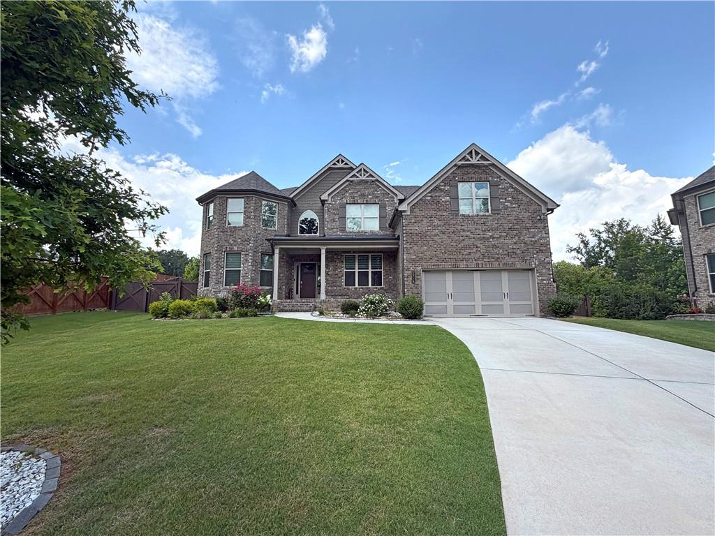 5296 Cheval Rue Court Suwanee, GA 30024 - Photo 2 of 51 a front view of a house with a yard