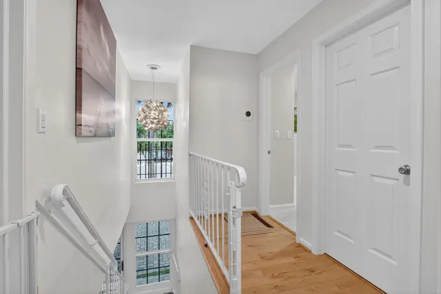a view of a livingroom with wooden floor and stairs