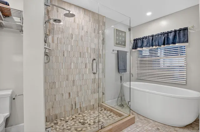 a bathroom with a bathtub and shower