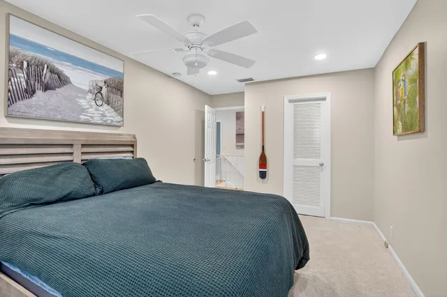 a bedroom with a large bed and a painting on the wall