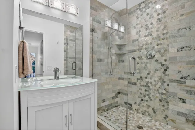 a bathroom with a shower and a sink