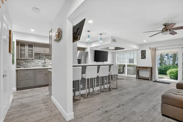 a view of kitchen with sink microwave and refrigerator
