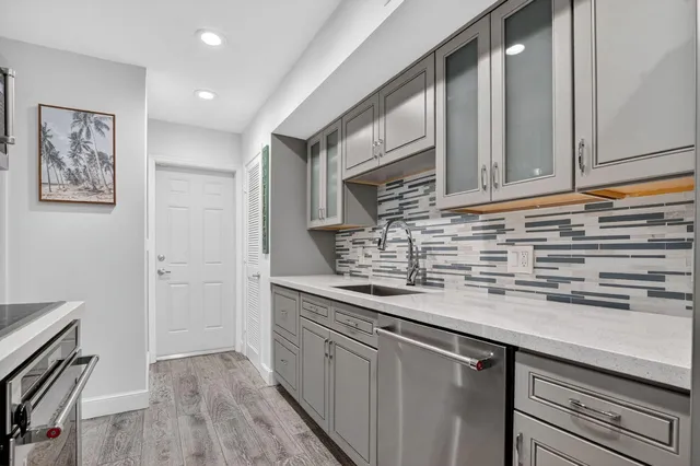 a kitchen with stainless steel appliances granite countertop a sink and cabinets