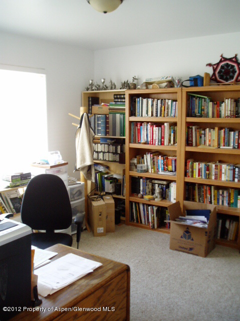 402 Evergreen Drive Rifle, CO 81650 - Photo 11 of 13 a living room with furniture and a book shelf