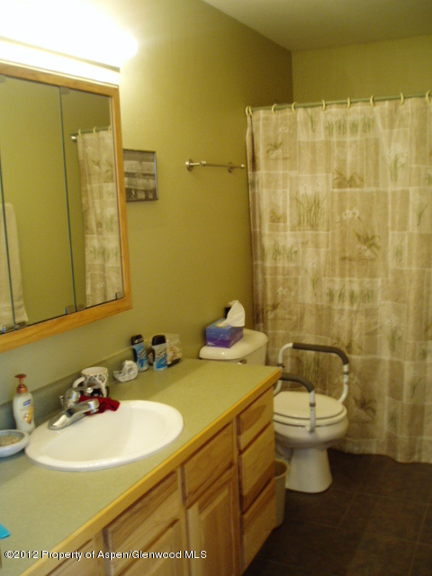 402 Evergreen Drive Rifle, CO 81650 - Photo 7 of 13 a bathroom with a sink a toilet and a mirror