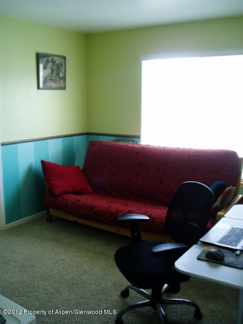 402 Evergreen Drive Rifle, CO 81650 - Photo 10 of 13 a room with furniture and a wooden floor
