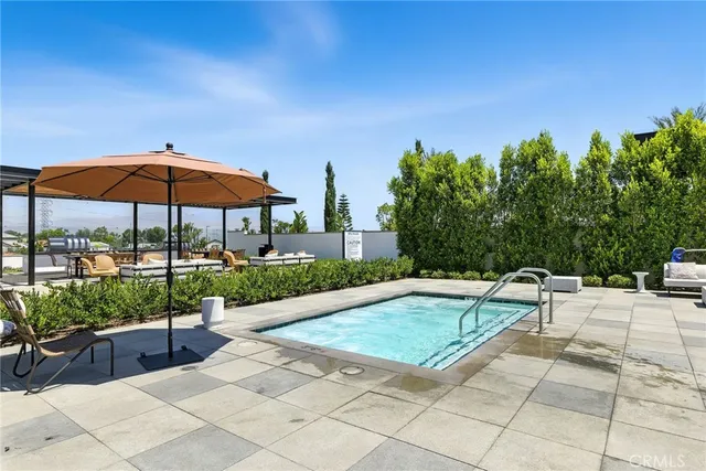 a view of swimming pool with outdoor seating and a terrace