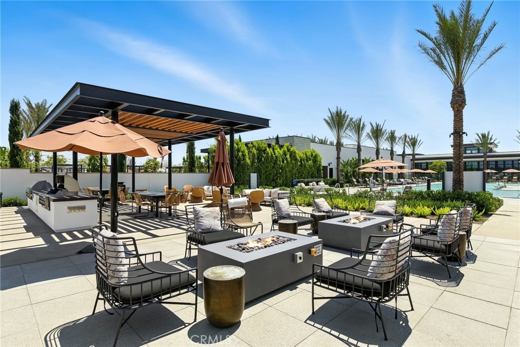 105 Remy Lane Montebello, CA 90640 - Photo 32 of 38 a view of patio with chairs and table under an umbrella with potted plants