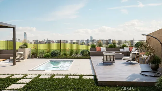 a view of a swimming pool with couches and lounge chairs