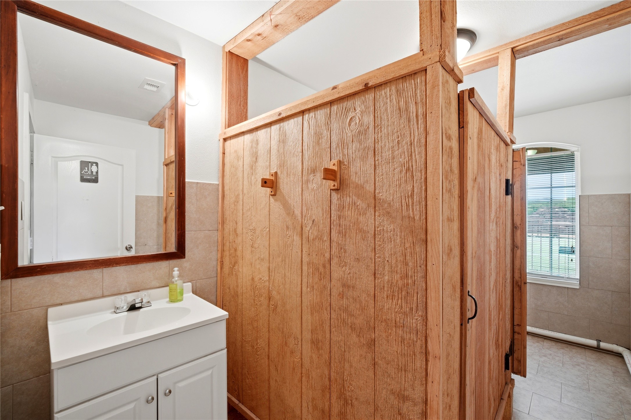 11741 Ezekiel Road Tomball, TX 77375 - Photo 16 of 30 a bathroom with a sink a mirror and a shower curtain