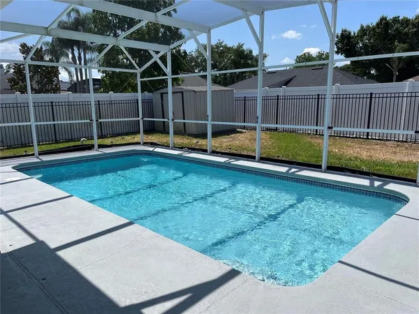 a view of a backyard with a swimming pool