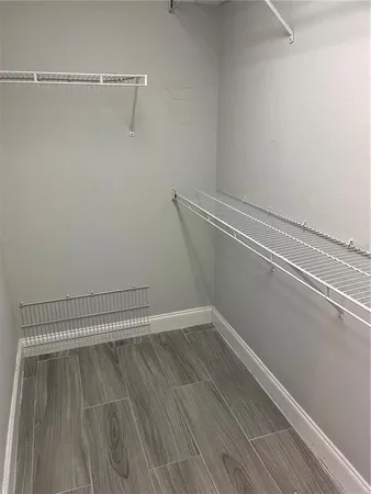 a view of a room with wooden floor